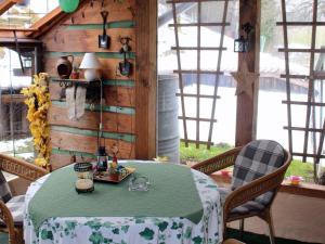 comedor con mesa, sillas y ventanas en Ferienwohnung Hirtenhaus, en Attendorn