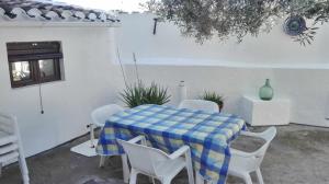 a blue and white table and chairs in a patio at Sierra Alcaide in Zagrilla