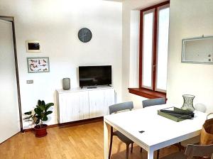 a living room with a table and a tv at Case Vacanze Berton Tirano in Tirano