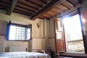Posteľ alebo postele v izbe v ubytovaní Appartamenti con cucina nelle colline toscane