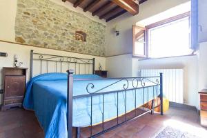 Posteľ alebo postele v izbe v ubytovaní Appartamenti con cucina nelle colline toscane
