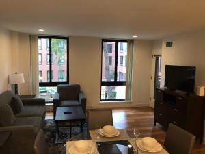 a living room with a couch and a tv at Boston Exclusive Corporate 30 Day Rental in Boston