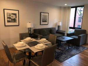 a living room with a table and chairs and a couch at Boston Exclusive Corporate 30 Day Rental in Boston