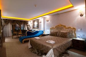 A bed or beds in a room at Grand Ambiance Hotel