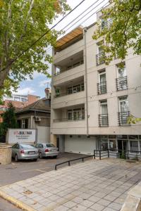 a building with cars parked in front of it at Villa Bulevar in Belgrade