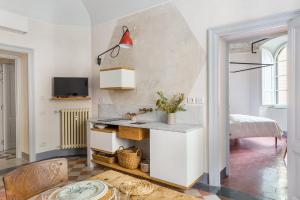 eine Küche mit einem Tisch und einem Bett in einem Zimmer in der Unterkunft Vuotopieno Roma apartments GREY e SAND in Rom