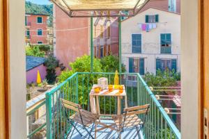 a table and chairs on the balcony of a apartment at LUIGINA House in Levanto