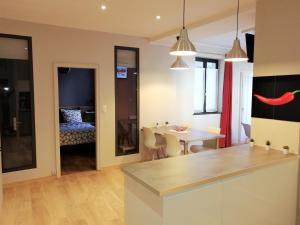 a kitchen with a table and a dining room at Gite Côté Cour Colmar in Colmar