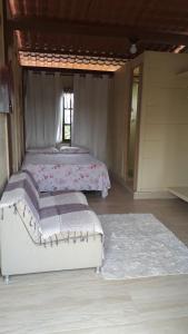 a bedroom with two beds and a rug at Apartamentos Caribe in João Pessoa