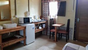 a small kitchen with a sink and a microwave at Apartamentos Caribe in João Pessoa