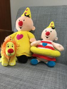 three stuffed winnie the pooh stuffed animals sitting on a couch at oyenkerke in De Panne