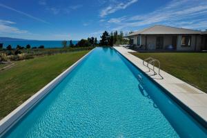 a swimming pool in the backyard of a house at Windhover Suites in Tasman