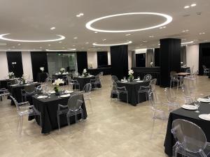 a banquet hall with tables and chairs with flowers on them at Hotel Delta in Durrës