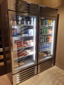 a refrigerator with its door open with food and drinks at Simple Suites Boise Airport in Boise