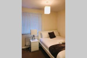 a small bedroom with a bed and a window at Smartrips Home Coventry in Parkside