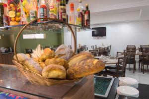 a basket of bread on a counter in a restaurant at Monte Serrat Hotel in Santos