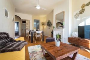 ein Wohnzimmer mit einem Sofa und einem Tisch in der Unterkunft MY CASA - GIOFFREDO 14 - APACHE - Spacious apartment with balcony in Nizza