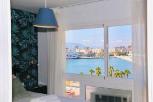 a room with a window with a view of the water at El Atardecer Skyline romantic views in Málaga