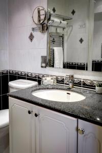 a bathroom with a sink and a mirror at Norfolk Royale Hotel in Bournemouth