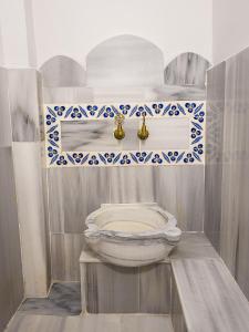 a bathroom with a toilet in the corner of a room at Duru Istanbul Apart in Istanbul