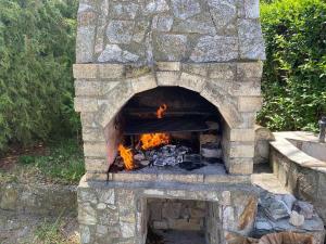 a stone oven with a fire inside of it at Complex Sea & Sky next to the Beach ! in Kranevo