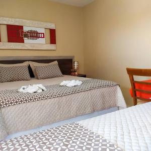 a bedroom with two beds with towels on them at Hotel Brisa do Aracati in Aracati