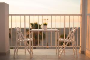 a white table and two chairs on a balcony at Sol Playa Suites in Valencia