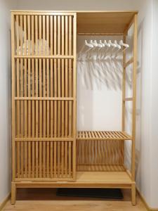 a wooden book shelf in a room at Sun apartments in Anykščiai