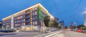 a large building on a city street with cars parked at Holiday Inn Dresden - Am Zwinger by IHG in Dresden