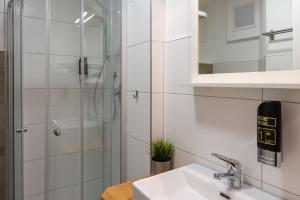 a bathroom with a sink and a shower at Hotel Post mit Klimaanlage in Neckarsulm