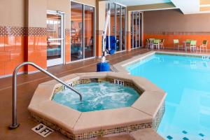 a pool with a hot tub in a hotel room at The Holiday Inn Amarillo West Medical Center, an IHG Hotel in Amarillo
