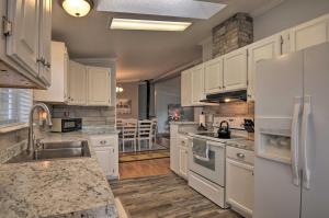 a kitchen with white appliances and a dining room at Bright and Beautiful Home, Explore Natl Parks! in Greenwich