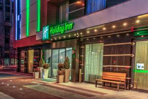 a store front with a bench in front of it at Holiday Inn Plovdiv by IHG in Plovdiv