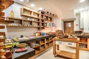 a large kitchen with lots of food on display at Holiday Inn Plovdiv by IHG in Plovdiv