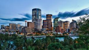 a city skyline with skyscrapers and a river at Holiday Inn Hotel & Suites Calgary South - Conference Ctr, an IHG Hotel in Calgary