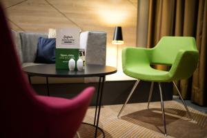 a chair and a table in a room at Holiday Inn Frankfurt Airport, an IHG Hotel in Frankfurt