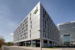 a large building with a clock on the front of it at Holiday Inn Frankfurt Airport, an IHG Hotel in Frankfurt