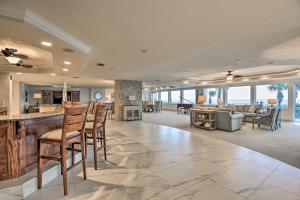 a large living room with a bar and a couch at Luxe Daytona Beach Resort Retreat with Ocean Views! in Daytona Beach Shores