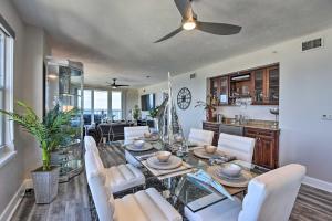 a dining room and living room with a table and chairs at Luxe Daytona Beach Resort Retreat with Ocean Views! in Daytona Beach Shores
