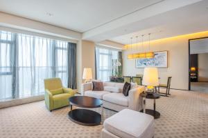 a living room with a couch and chairs and a table at Holiday Inn Nantong Oasis International by IHG in Nantong