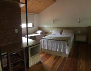 a bedroom with a large bed and a window at Casa de São Jorge in Pirenópolis +3 photos