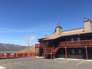 a building with a parking lot next to a lake at Big Bear Frontier in Big Bear Lake