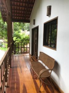 a patio with a chair and a table on a porch at Casa de São Jorge in Pirenópolis