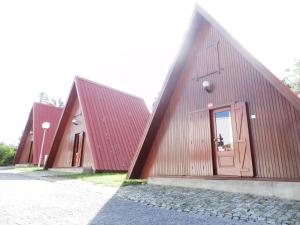 a group of three buildings with red roofs at parque de campismo de Luso in Luso