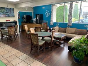 a living room with a couch and a table and chairs at Travel Inn Kingsport in Kingsport