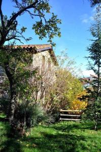 a building in the middle of a yard with trees at La Quinta Del Chocolatero in El Barco de Ávila