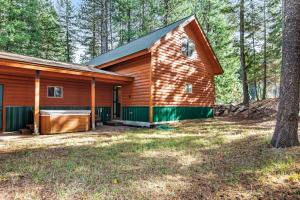 a cabin in the woods with a tree at Deer Trail in McCall