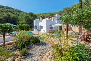 a villa with a view of a resort at Charming villa with pool, Can Toni Mateu. in Sant Carles de Peralta