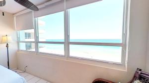 a bedroom with a window with a view of the beach at Castle 922 in Miami Beach