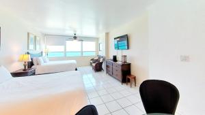 a hotel room with a bed and a tv at Castle 922 in Miami Beach